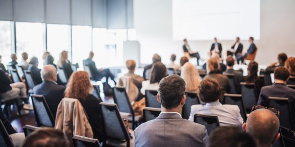 Interview and round table discussion at business convention and presentation. Audience at the conference hall. Business and entrepreneurship symposium.